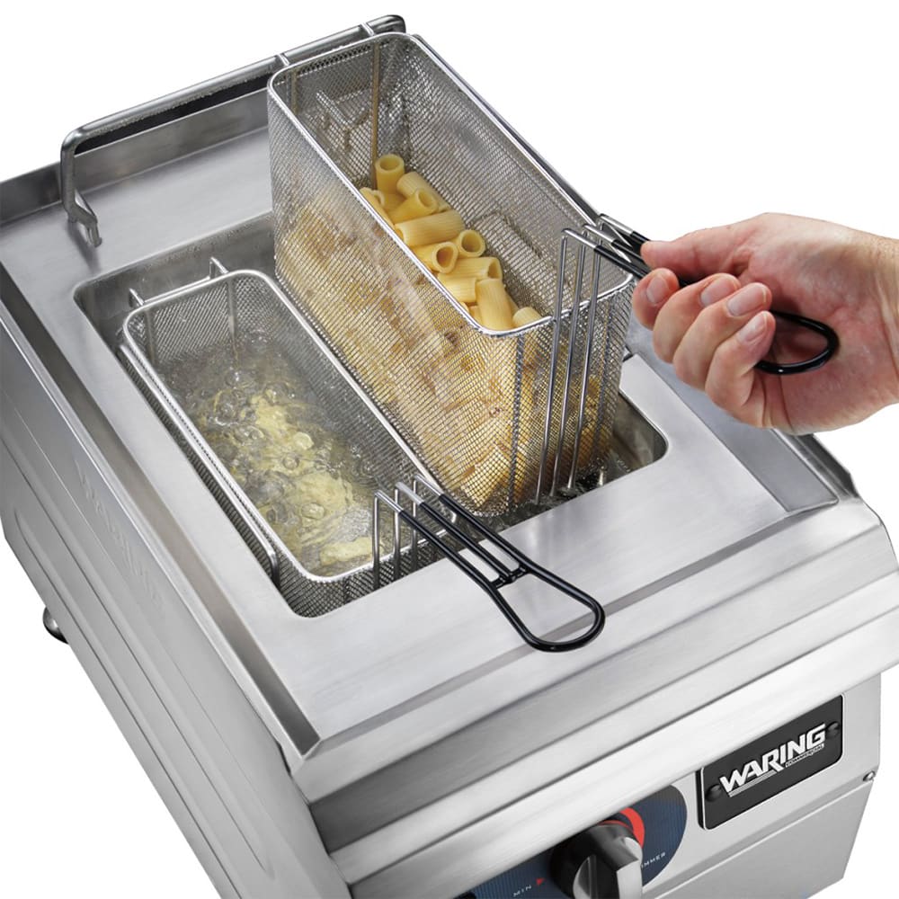 Waring deep fryer with food being fried, showing a hand lifting a basket.