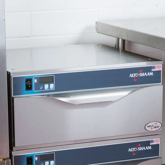 Stainless steel kitchen equipment with Alto-Shaam branding on a white tiled wall background