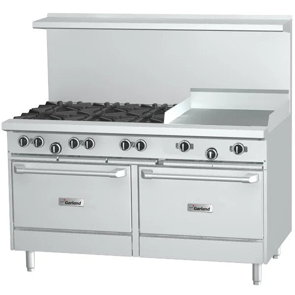 Stainless steel commercial range with multiple burners and griddle on a white background