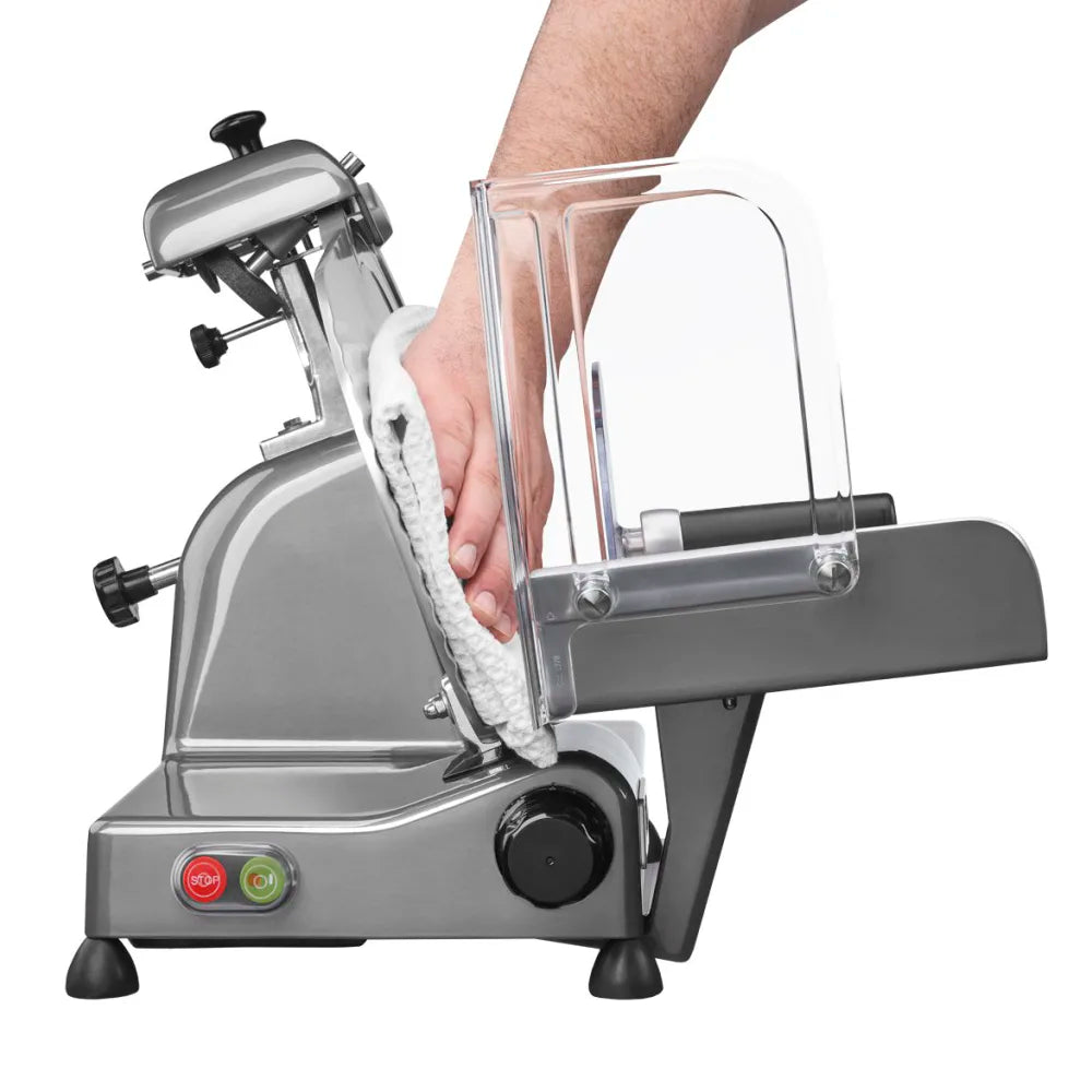 Metallic food slicer with a hand holding a clear plastic cover on a white background