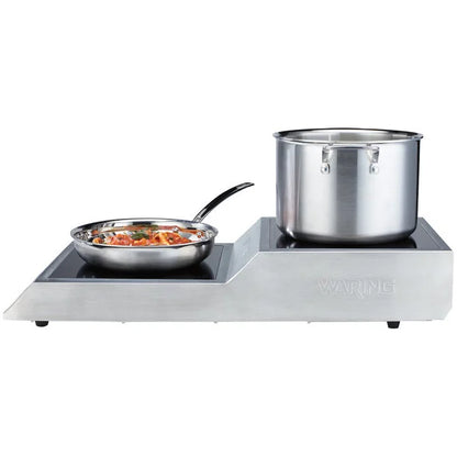 Stainless steel hot plate with a pot and pan on a white background