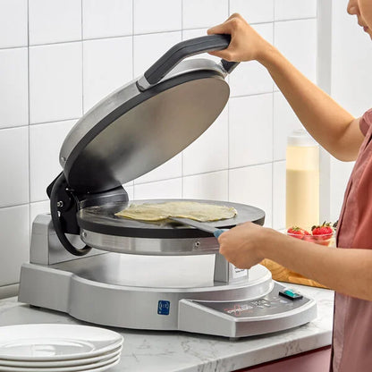 Person using a tortilla press with food inside on a kitchen counter.